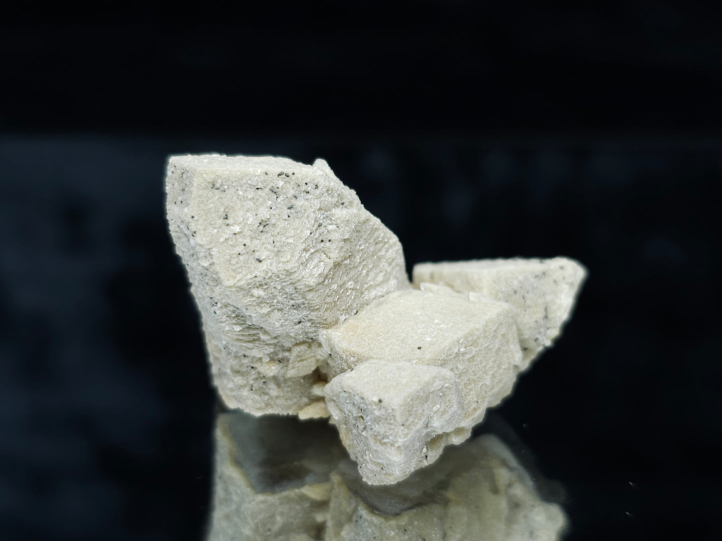 #88028 Hematite on cream-white Calcite pseudomorph after twin Combined form Calcite