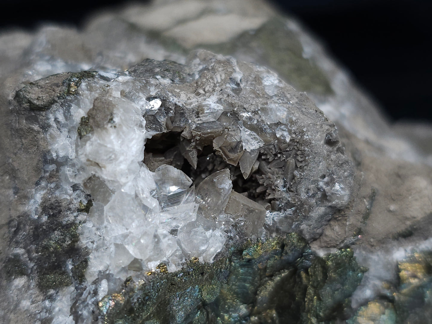 #66027 Hydrothermal mineral deposit that have peacock Chalcopyrite ore with small Dogtooth Spar Calcite geode and multiple fossils