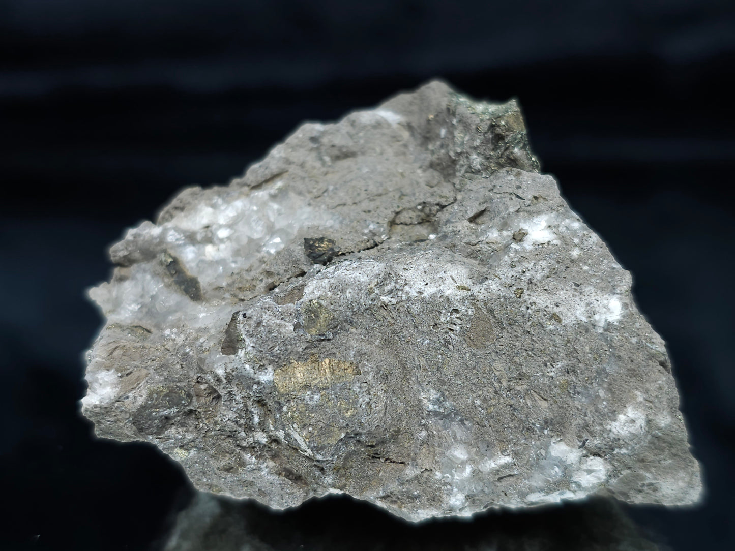 #66110 Iridescent Chalcopyrite ore with hydrothermal Chalcopyrite and Calcite deposit trought multiple small fossils