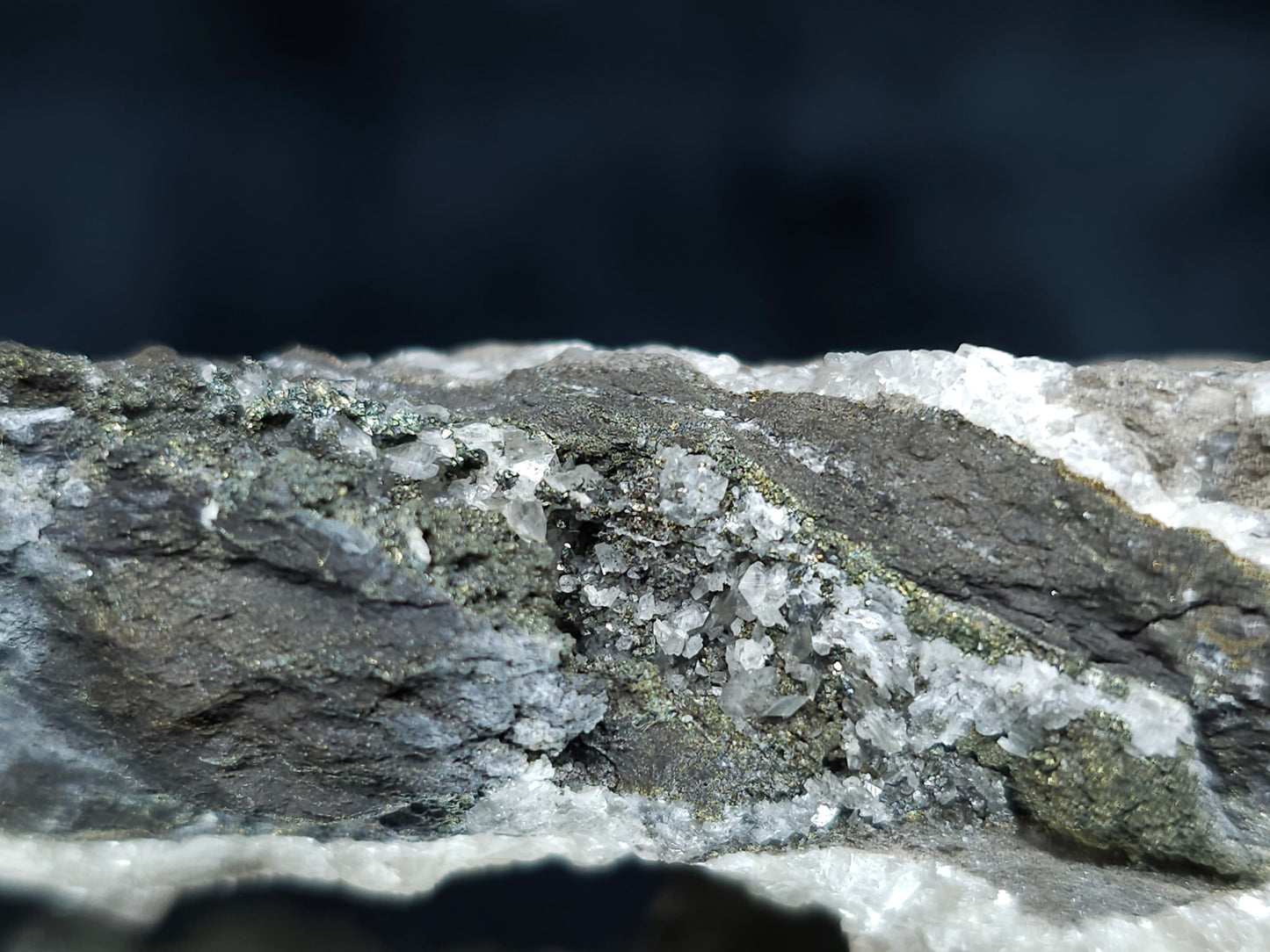 #66117 Nailhead Spar Calcite on peacock Chalcopyrite ore among fossil flower with Chalcopyrite coating water clear Nailhead Spar Calcite formation on multiple small fossils