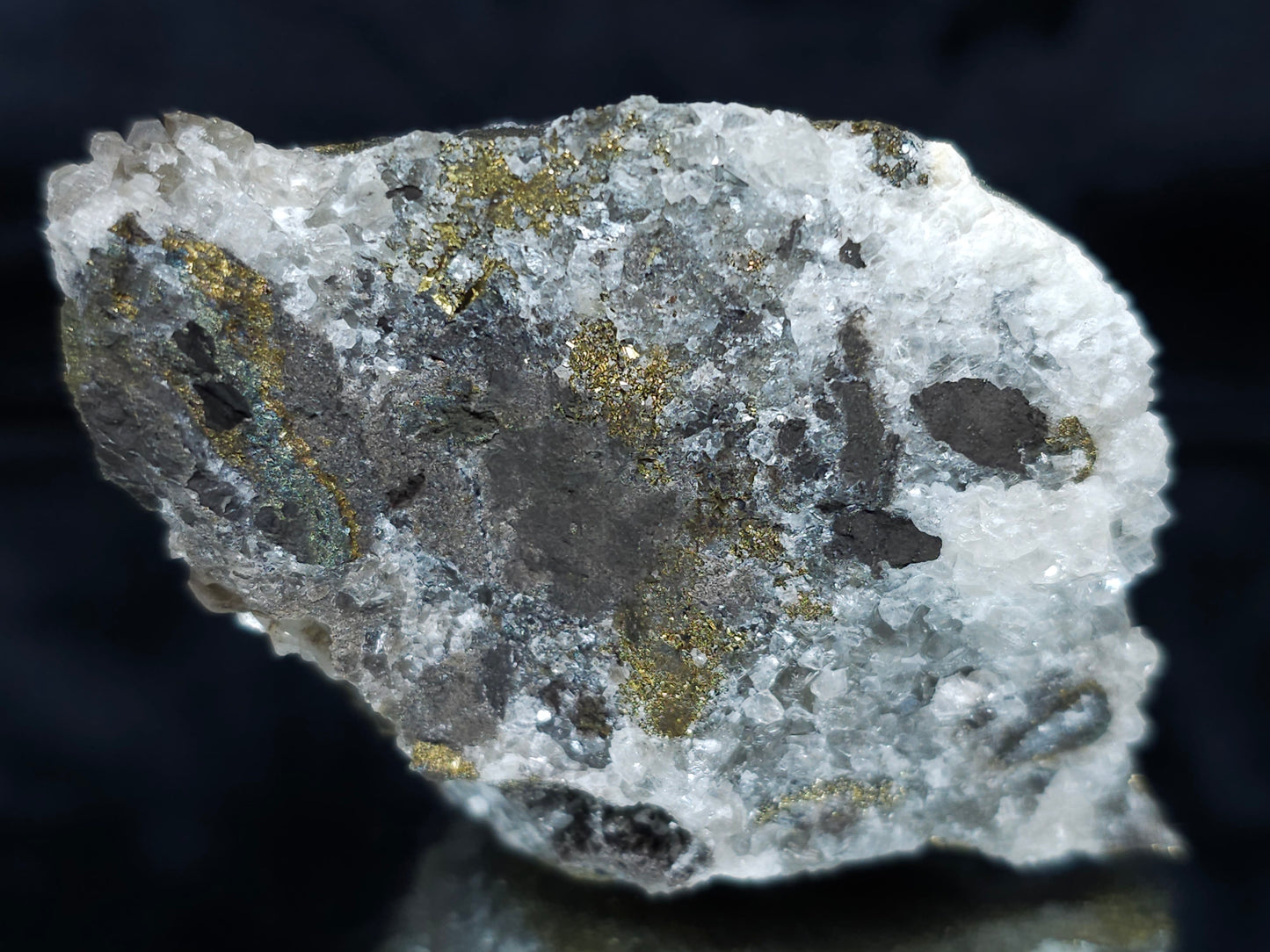 #66130 Hydrothermal iridescent golden and peacock Chalcopyrite ore deposit with hydrothermal Calcite deposit with Marcasite on multiple small fossils