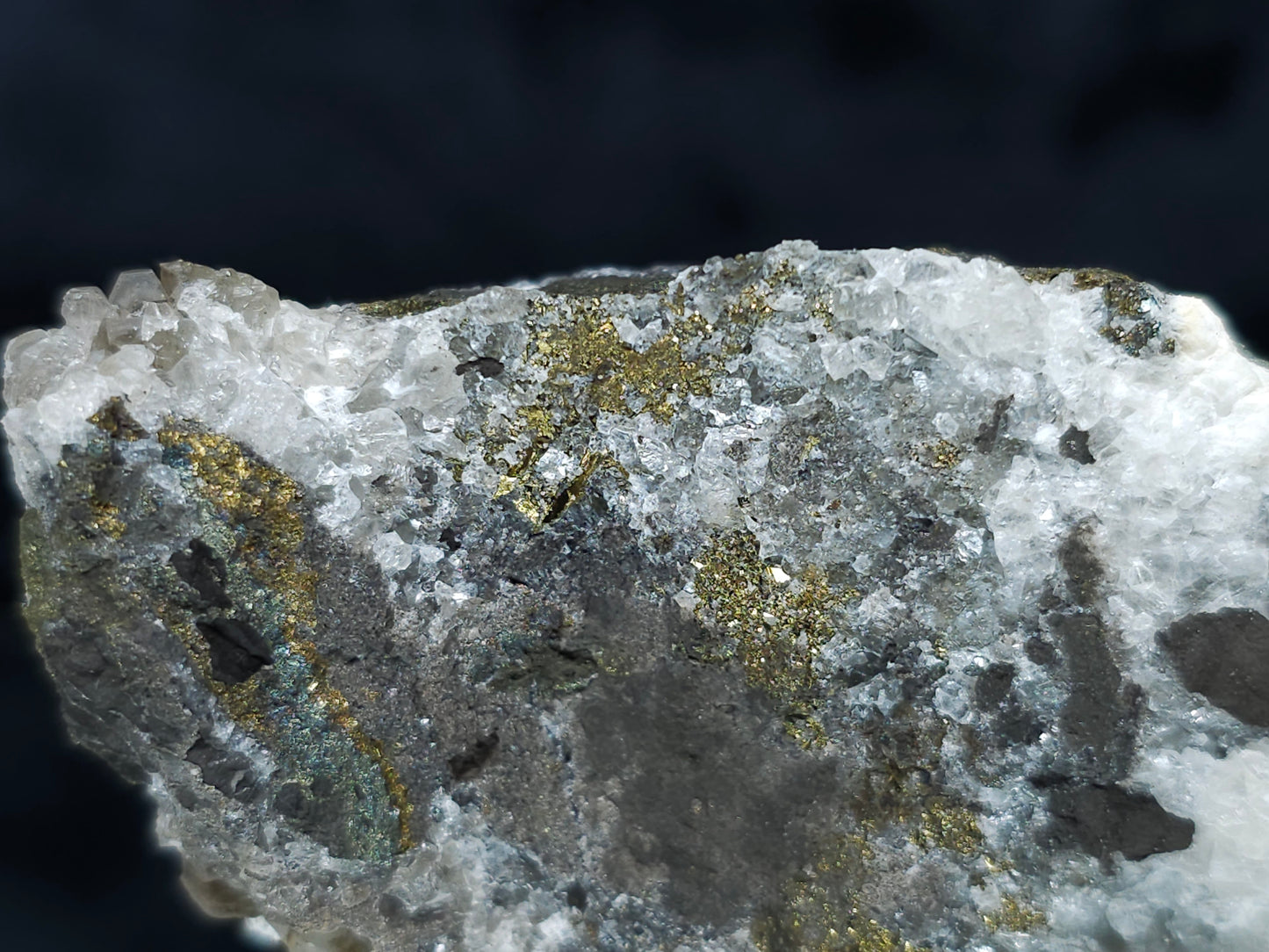 #66130 Hydrothermal iridescent golden and peacock Chalcopyrite ore deposit with hydrothermal Calcite deposit with Marcasite on multiple small fossils