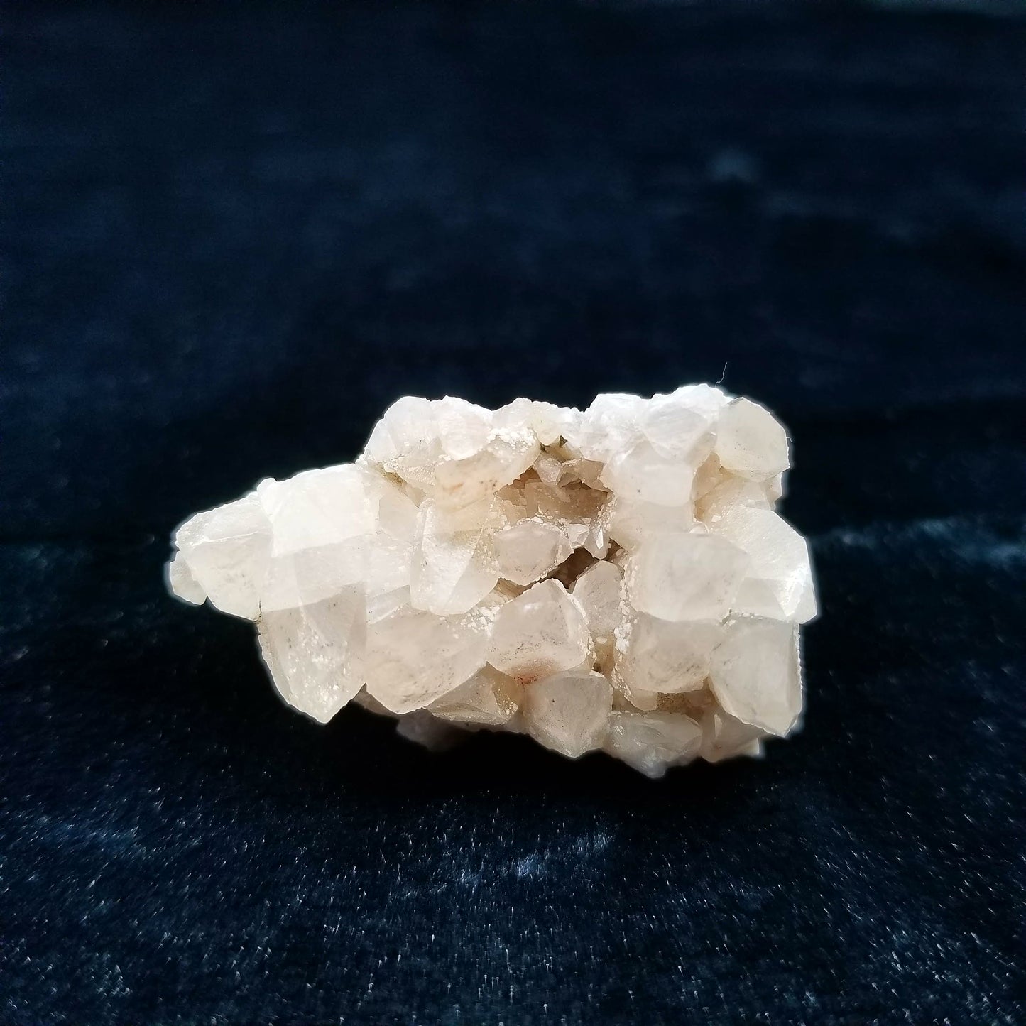 #11131 White Dolomite coating on clear Combined form Calcite with Hematite inclusions